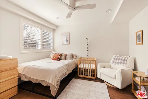 a bedroom with two beds and a window