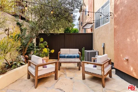 a backyard of a house with outdoor seating