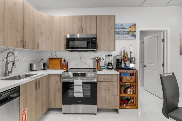 a kitchen with a sink a stove and refrigerator