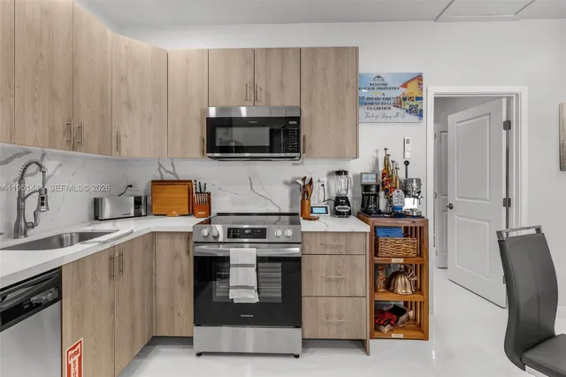 a kitchen with a sink a stove and refrigerator