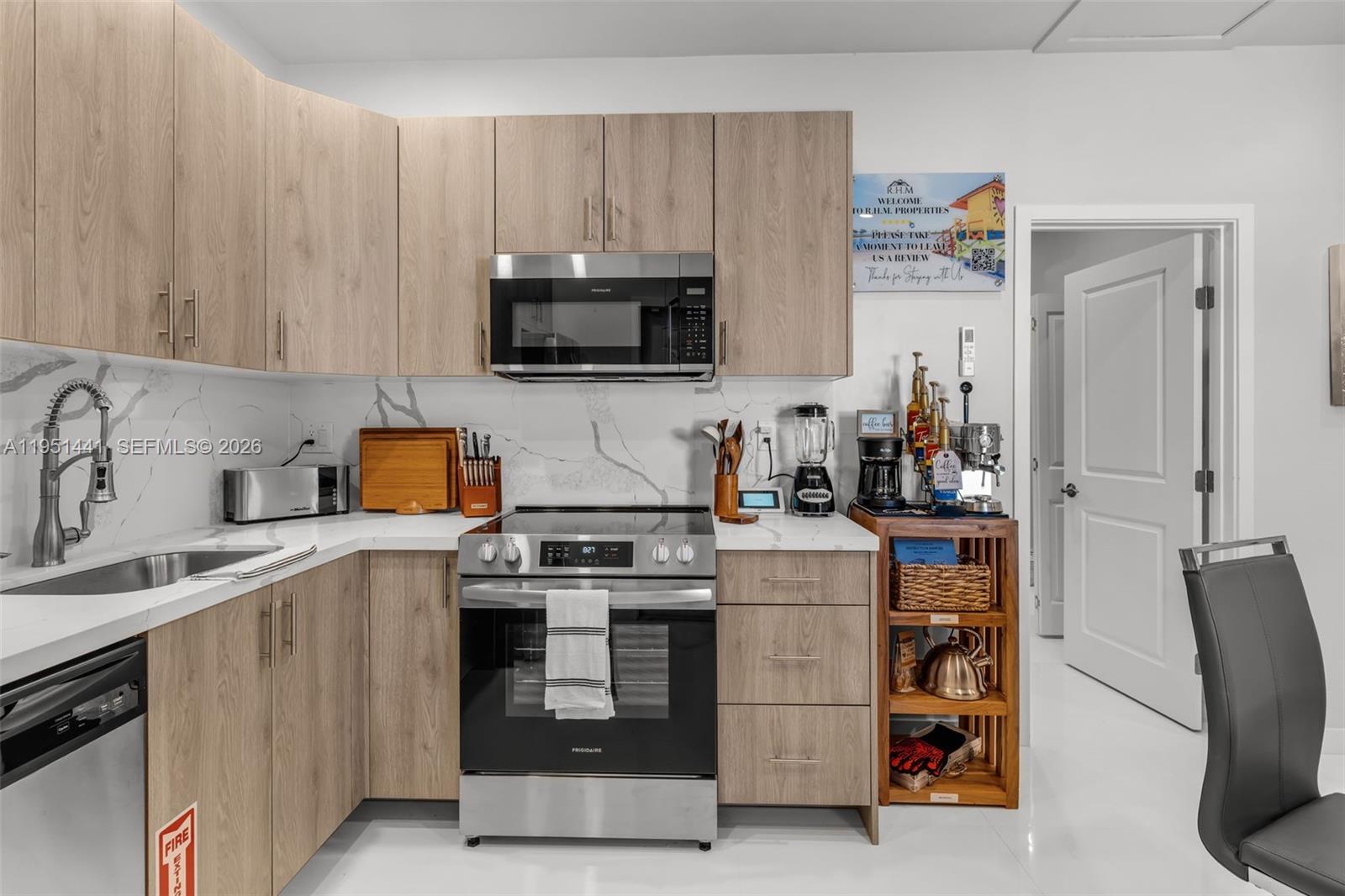 a kitchen with a sink a stove and refrigerator