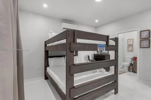 a bedroom with a bed and a night stand