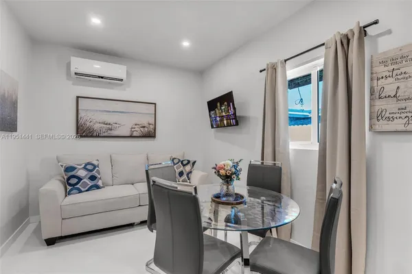 a living room with furniture and a painting on the wall