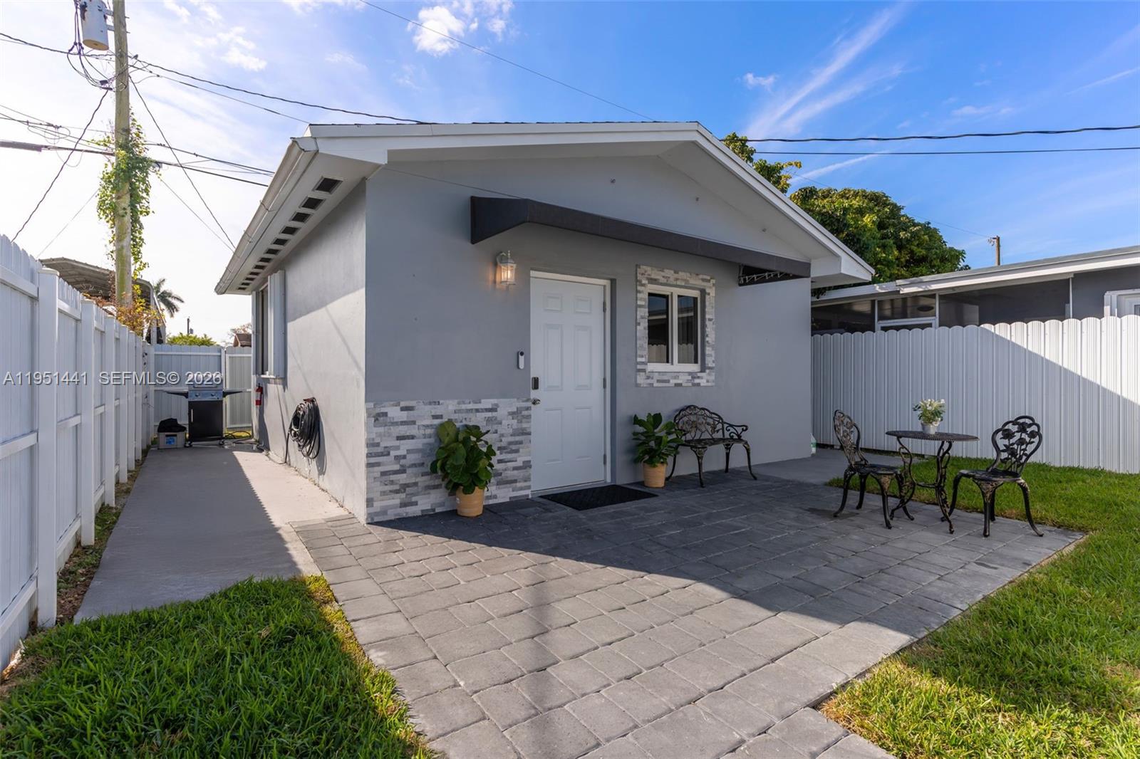 1430 Northeast 11th Street, Unit 1430 Homestead, FL 33033 - Photo 9 of 21 a front view of a house with garden