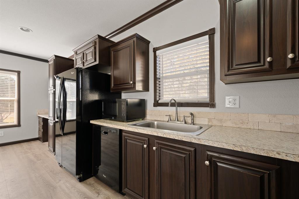 9419 Hilltop Street Rio Vista, TX 76093 - Photo 15 of 40 a kitchen with stainless steel appliances granite countertop a sink stove and refrigerator