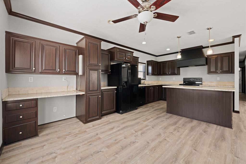 9419 Hilltop Street Rio Vista, TX 76093 - Photo 19 of 40 a kitchen with stainless steel appliances granite countertop a refrigerator and a sink