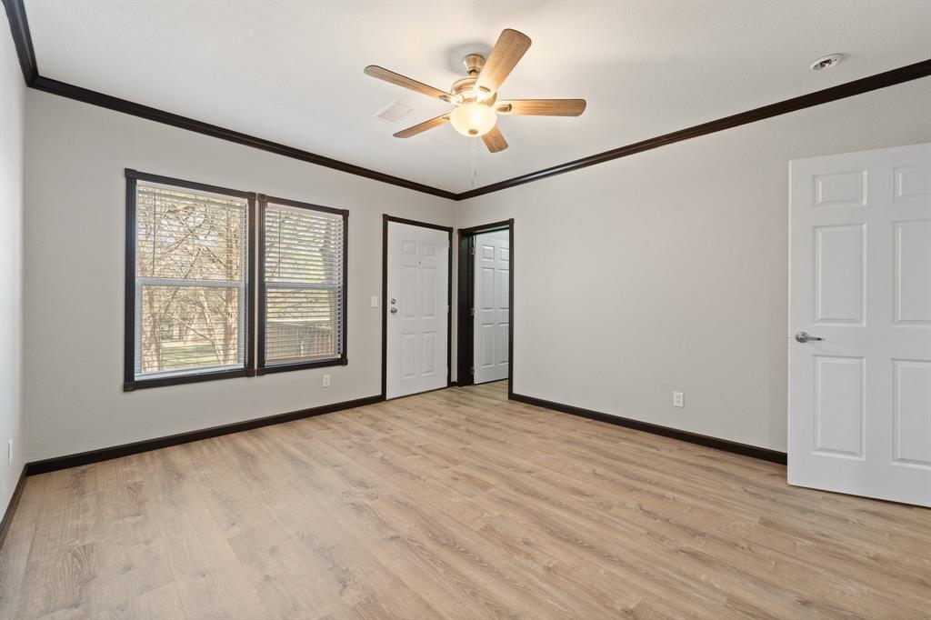 9419 Hilltop Street Rio Vista, TX 76093 - Photo 23 of 40 a view of an empty room with a window and a ceiling fan