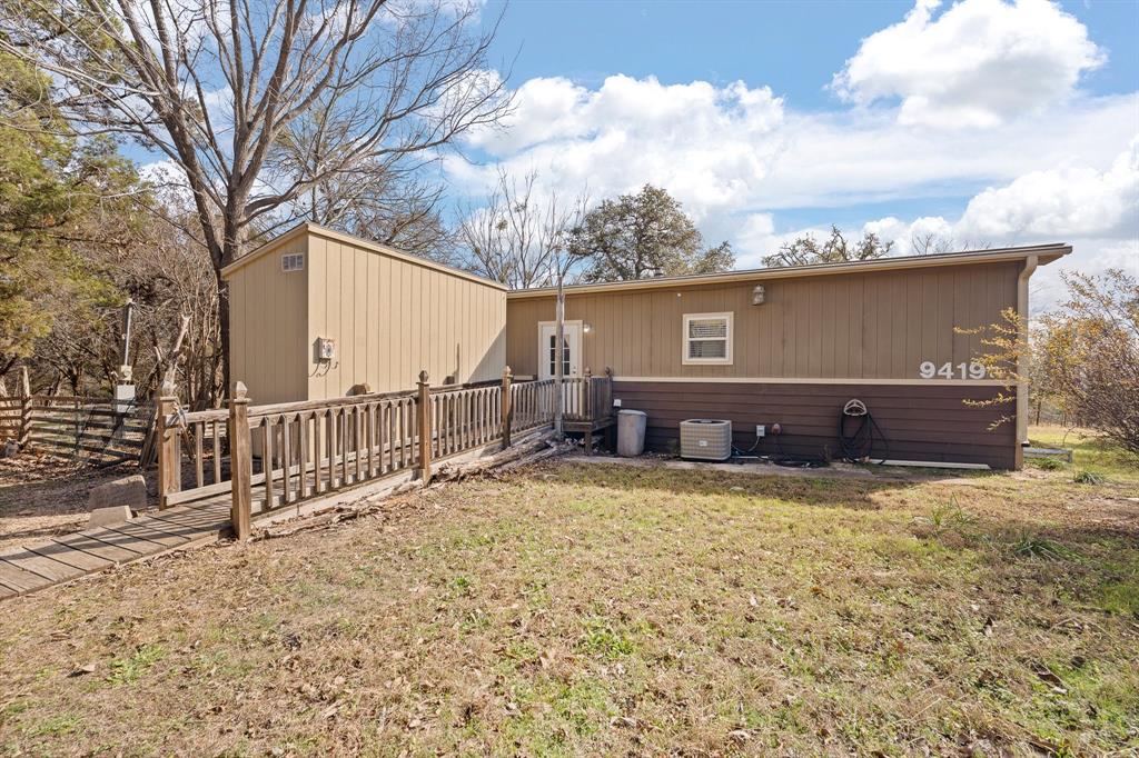 9419 Hilltop Street Rio Vista, TX 76093 - Photo 8 of 40 a view of house with backyard and trees