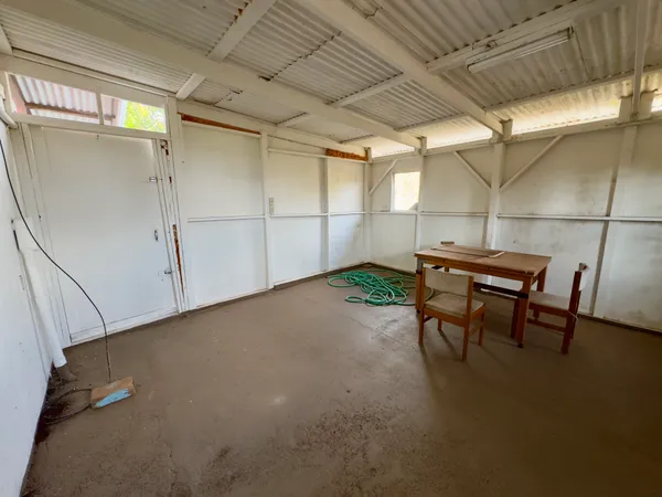 a view of a room with table and a window