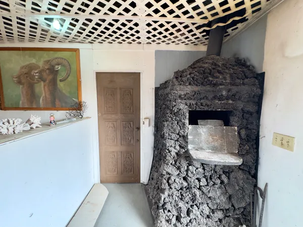 a stone house with a fireplace