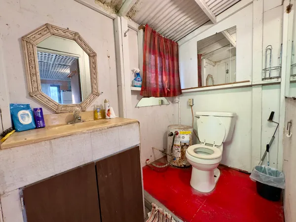 a bathroom with a sink vanity mirror and toilet