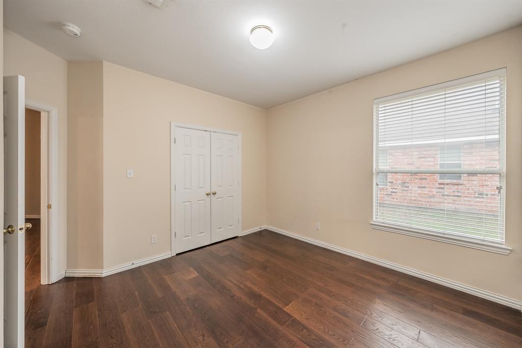 2306 Bear Run Road Arlington, TX 76001 - Photo 12 of 40 Unfurnished bedroom with dark wood-type flooring and a closet