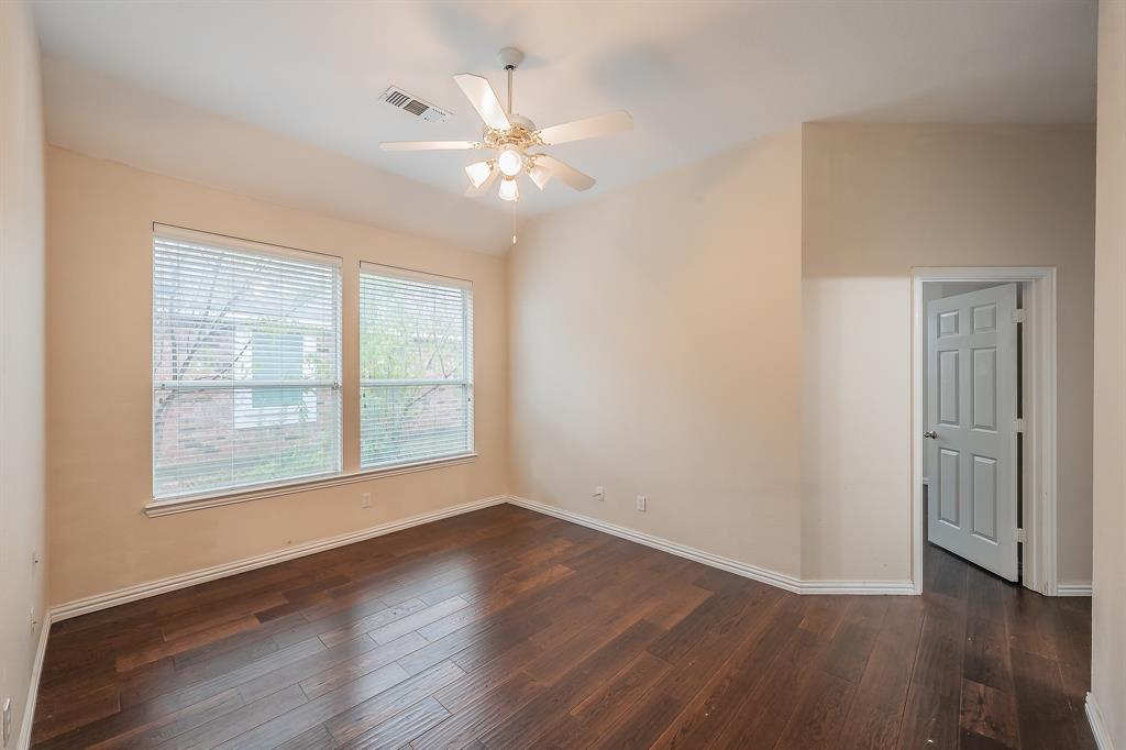 2306 Bear Run Road Arlington, TX 76001 - Photo 18 of 40 Empty room with dark wood-type flooring, ceiling fan, and lofted ceiling
