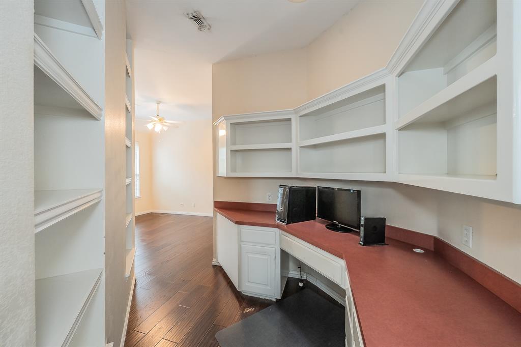 2306 Bear Run Road Arlington, TX 76001 - Photo 20 of 40 Unfurnished office featuring built in desk, ceiling fan, and dark wood-style flooring