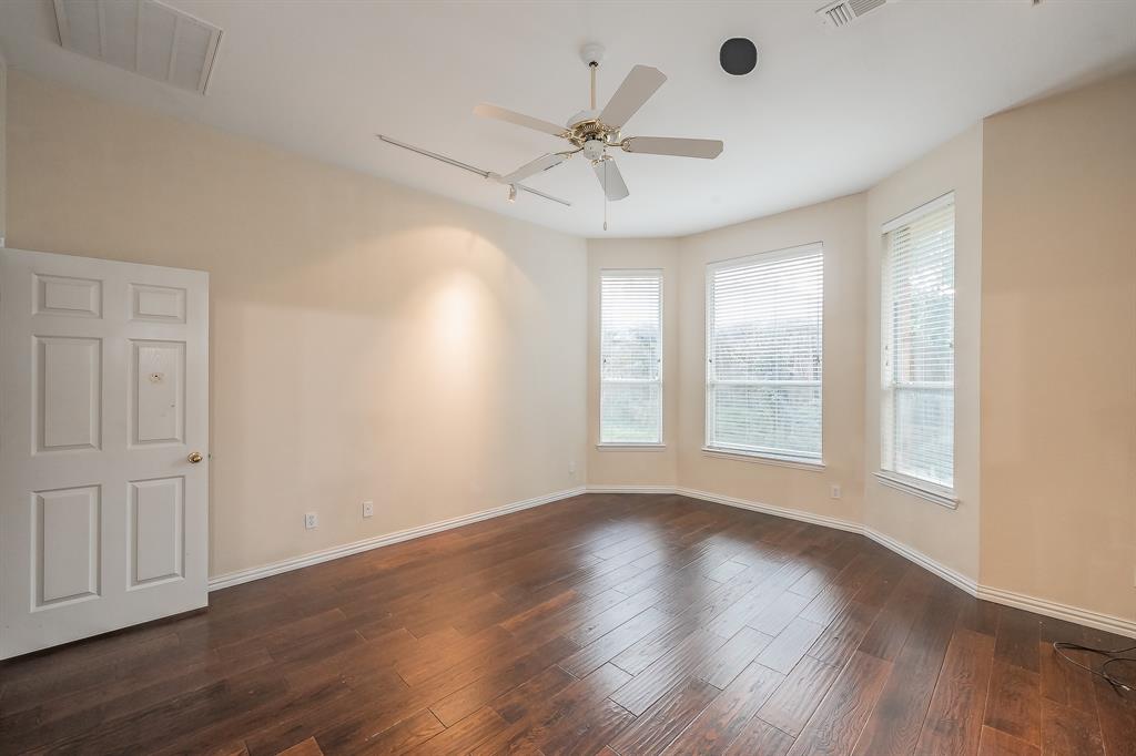 2306 Bear Run Road Arlington, TX 76001 - Photo 22 of 40 Empty room with dark wood-style floors and ceiling fan