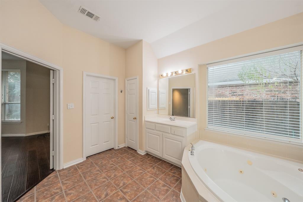 2306 Bear Run Road Arlington, TX 76001 - Photo 26 of 40 Bathroom with healthy amount of natural light, a jetted tub, and vanity