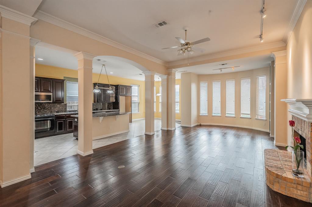 2306 Bear Run Road Arlington, TX 76001 - Photo 30 of 40 Living room with decorative columns, wood tiled floors, crown molding, track lighting, and a ceiling fan