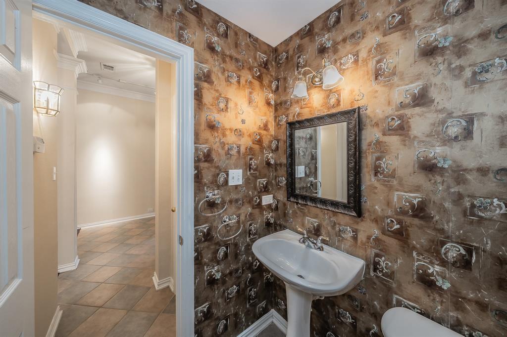 2306 Bear Run Road Arlington, TX 76001 - Photo 5 of 40 Half bath with crown molding and tile patterned floors