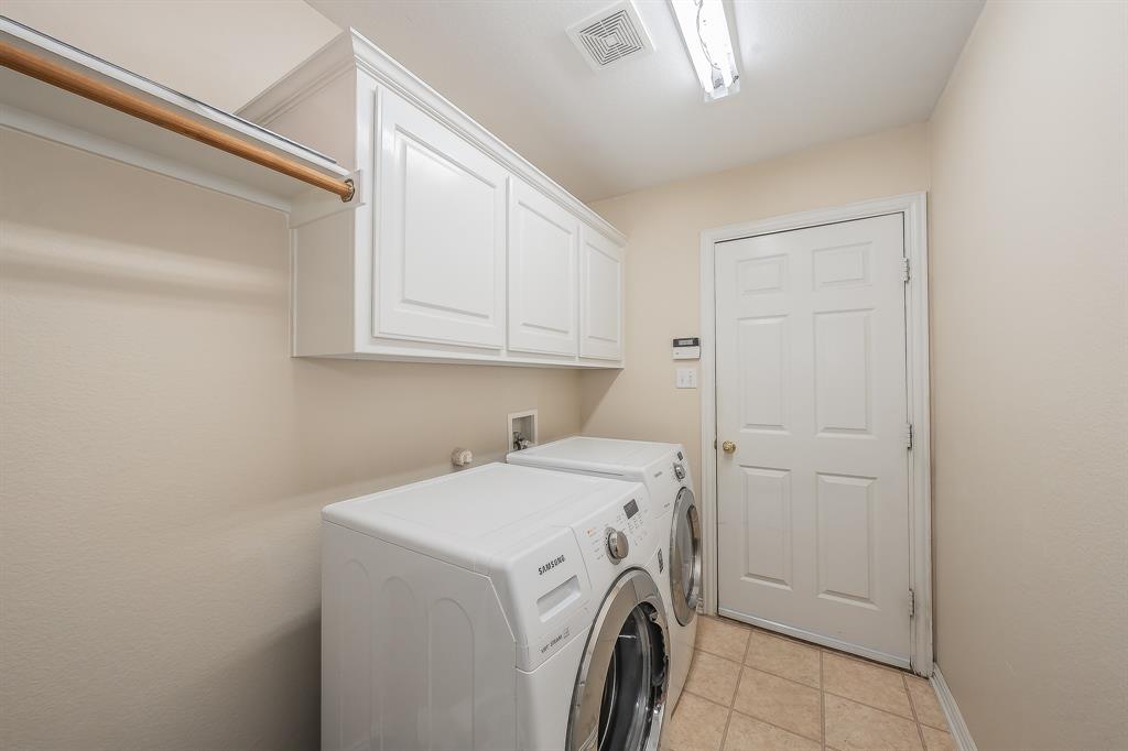 2306 Bear Run Road Arlington, TX 76001 - Photo 6 of 40 Laundry room with washer and dryer, cabinet space, and light tile patterned flooring