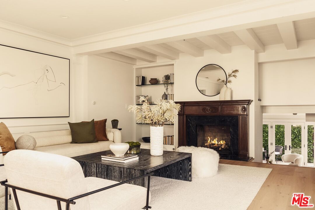 222 14th Street Santa Monica, CA 90402 - Photo 12 of 42 a living room with furniture a clock and a fireplace
