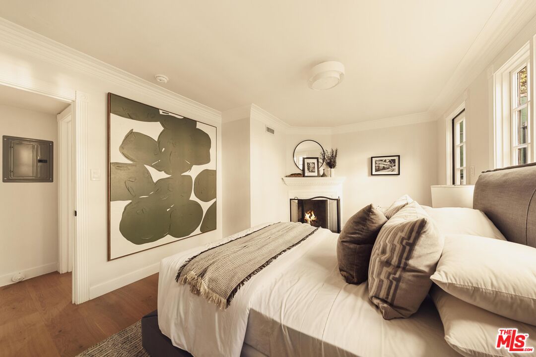 222 14th Street Santa Monica, CA 90402 - Photo 16 of 42 a bedroom with a bed and glass window