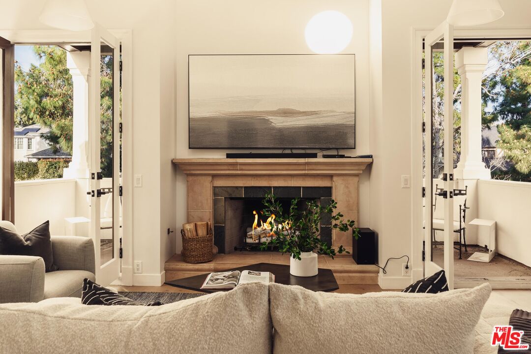222 14th Street Santa Monica, CA 90402 - Photo 23 of 42 a living room with furniture a flat screen tv and a fireplace