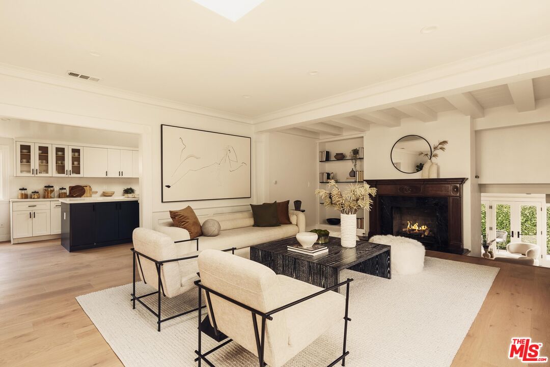 222 14th Street Santa Monica, CA 90402 - Photo 5 of 42 a living room with furniture a fireplace and kitchen view
