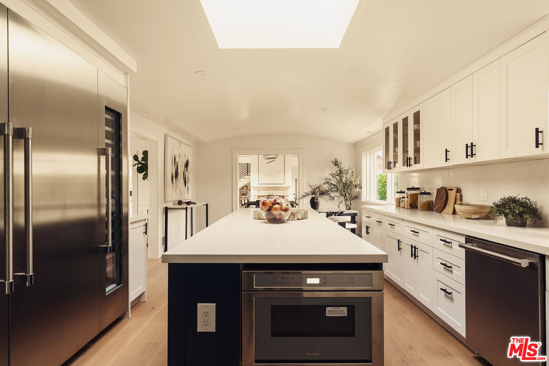 222 14th Street Santa Monica, CA 90402 - Photo 7 of 42 a kitchen with a sink stainless steel appliances and white cabinets