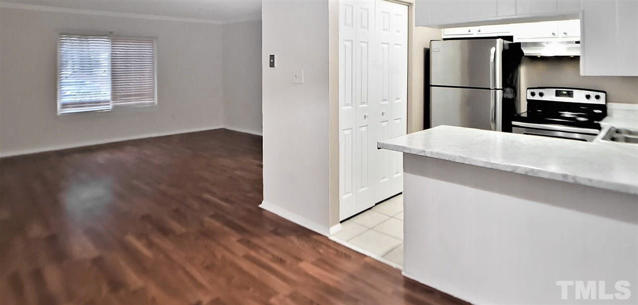 5804 Falls Of Neuse Road, Unit A Raleigh, NC 27609 - Photo 2 of 9 a kitchen with a refrigerator and a stove top oven