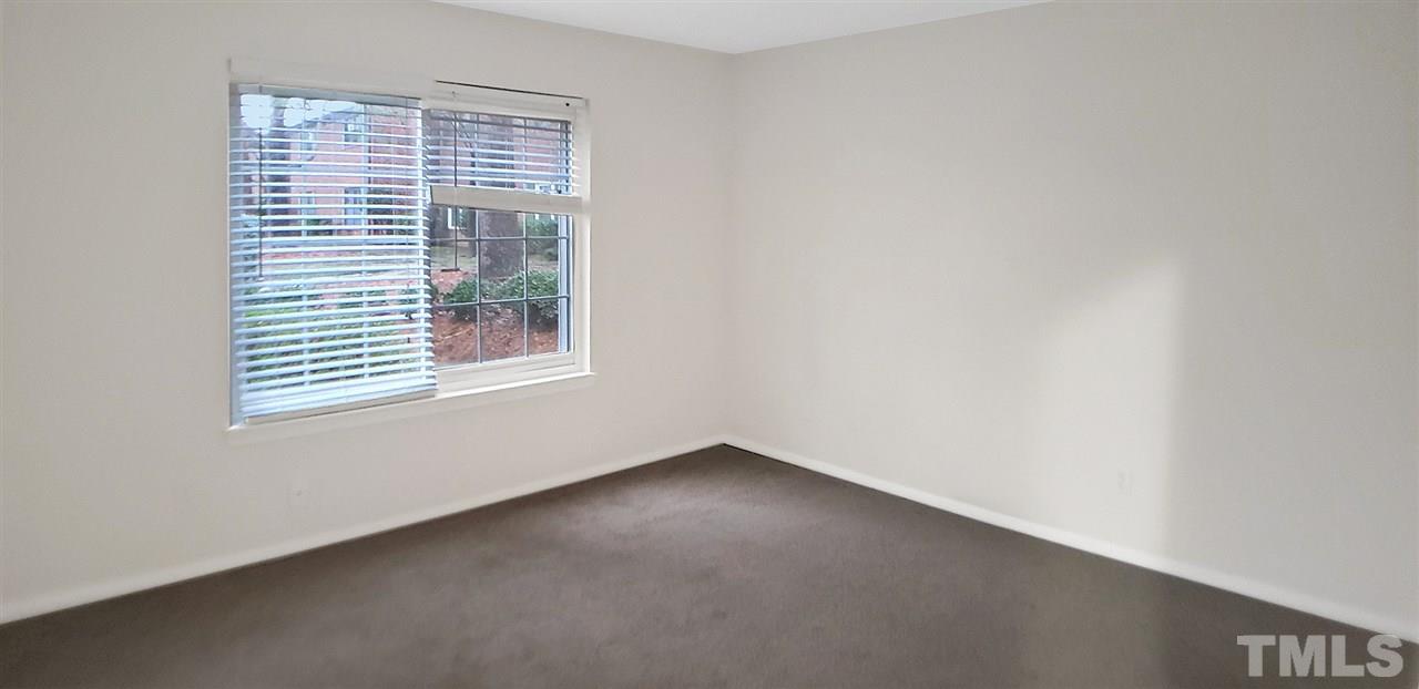 5804 Falls Of Neuse Road, Unit A Raleigh, NC 27609 - Photo 6 of 9 an empty room with a window