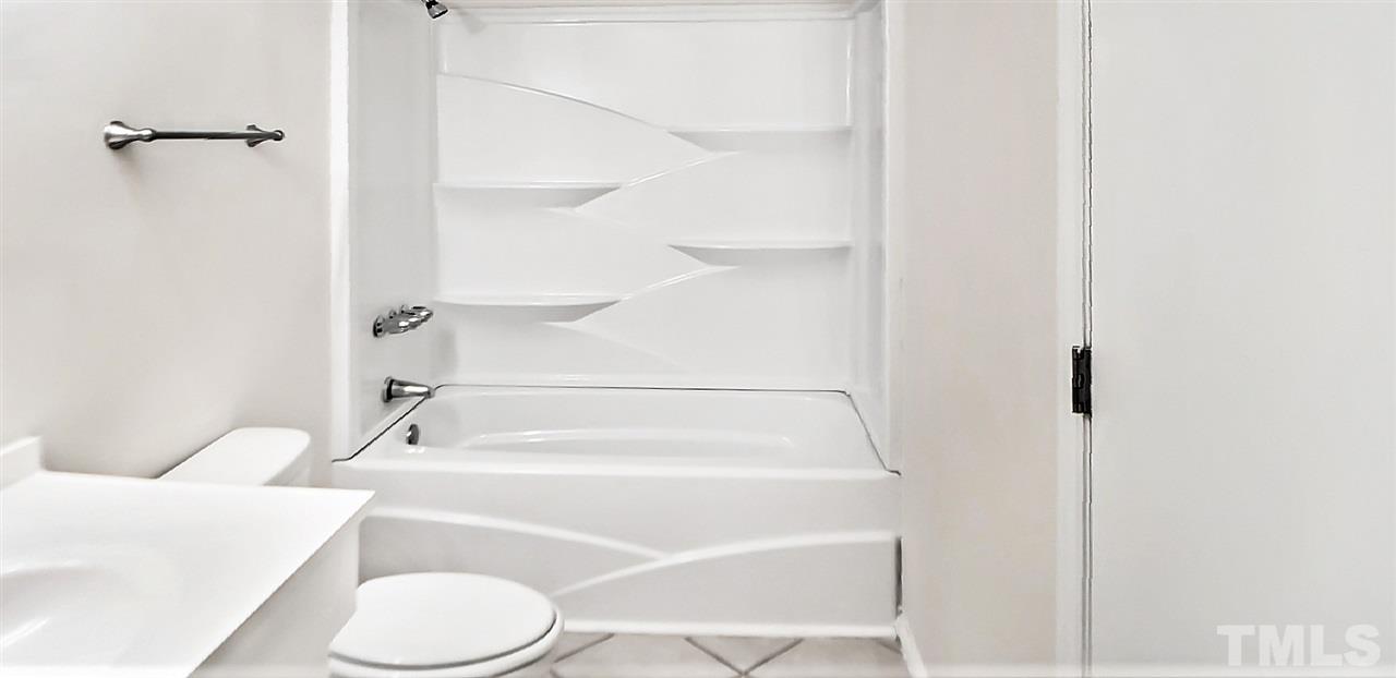 5804 Falls Of Neuse Road, Unit A Raleigh, NC 27609 - Photo 7 of 9 a bathroom with a bathtub and a toilet
