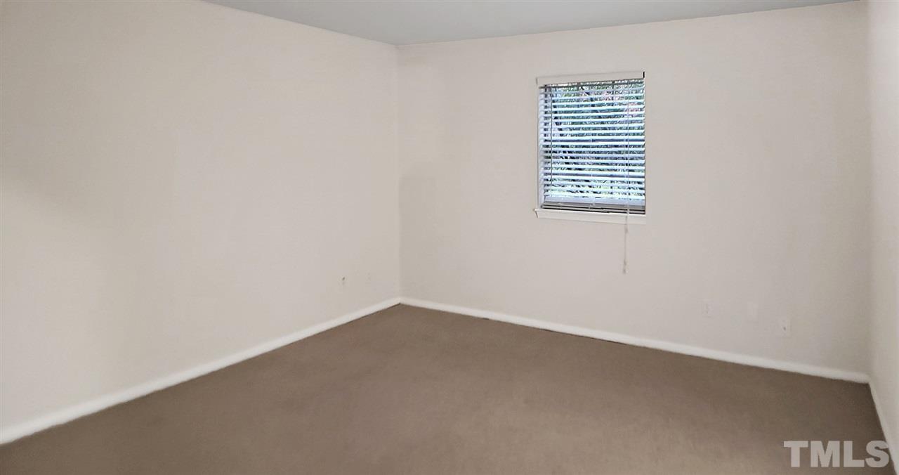 5804 Falls Of Neuse Road, Unit A Raleigh, NC 27609 - Photo 8 of 9 an empty room with a window