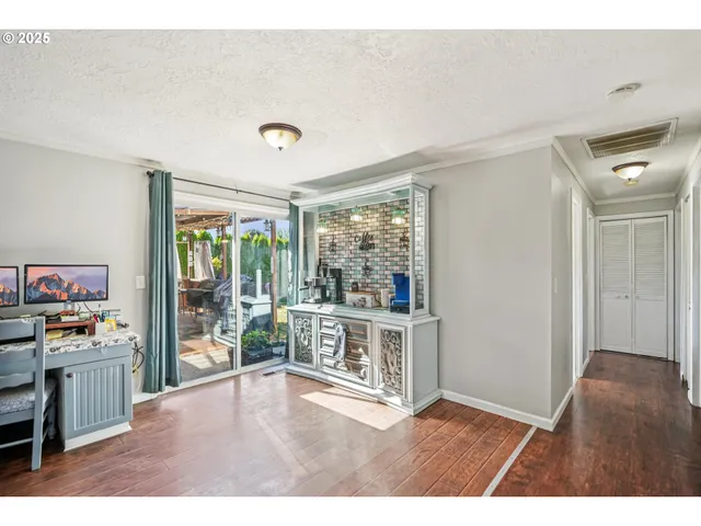 a open kitchen with white cabinets and wooden floor