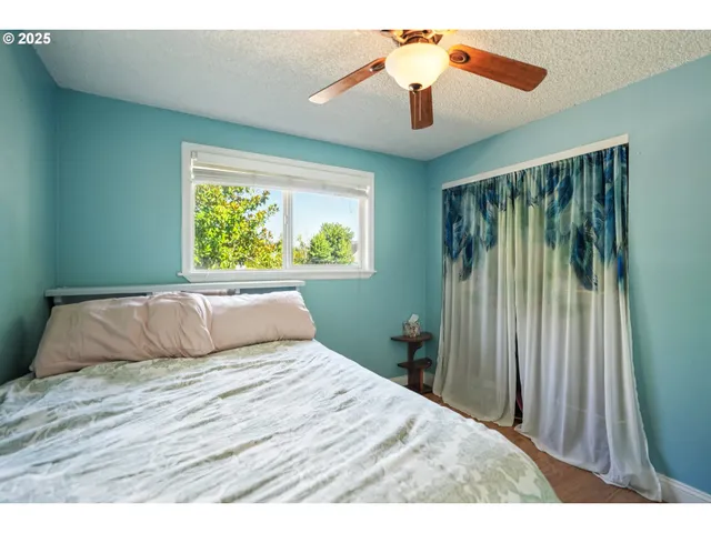 a bedroom with a large bed and a chandelier
