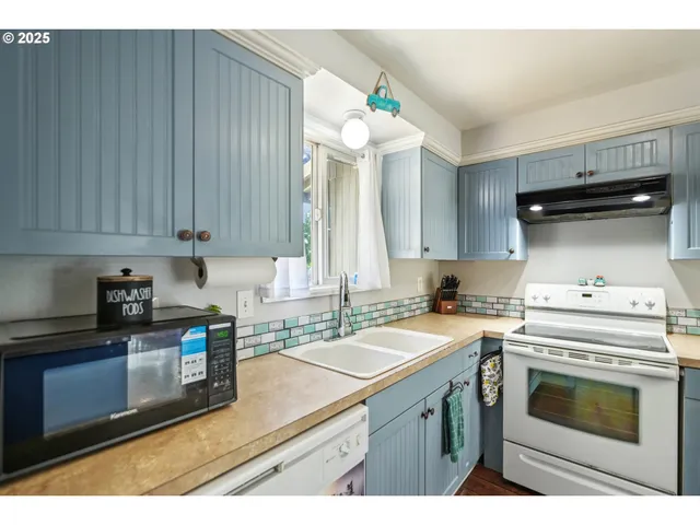 a kitchen with a sink stove and cabinets