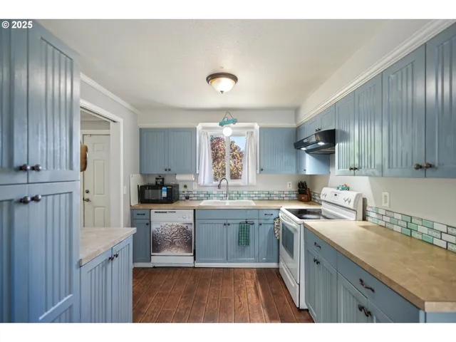 a kitchen with a sink stove and cabinets