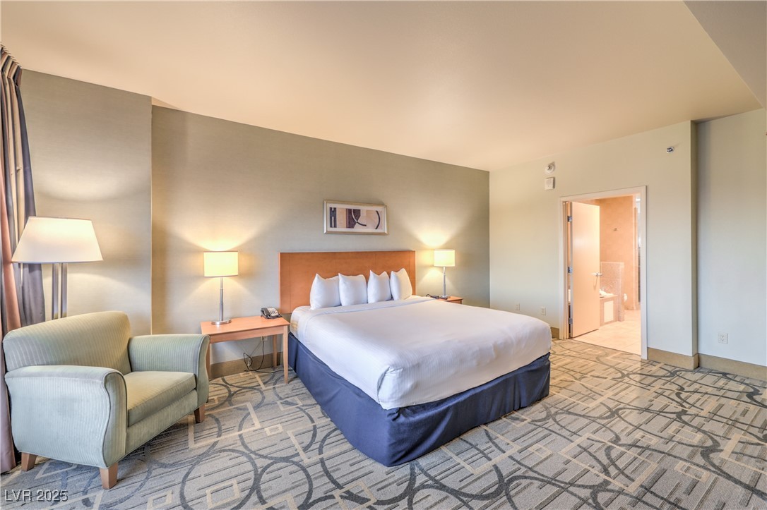 211 East Flamingo Road, Unit 1508 Las Vegas, NV 89169 - Photo 20 of 40 Carpeted bedroom featuring ensuite bath
