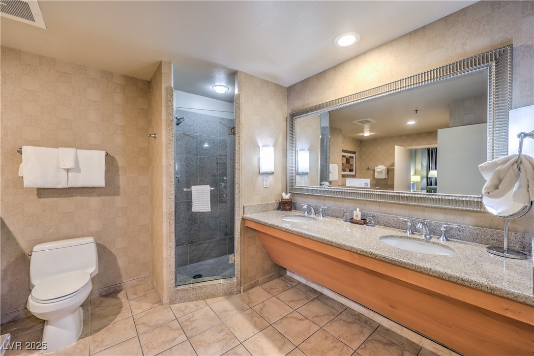 211 East Flamingo Road, Unit 1508 Las Vegas, NV 89169 - Photo 22 of 40 Bathroom featuring double vanity, a shower stall, and light tile patterned floors