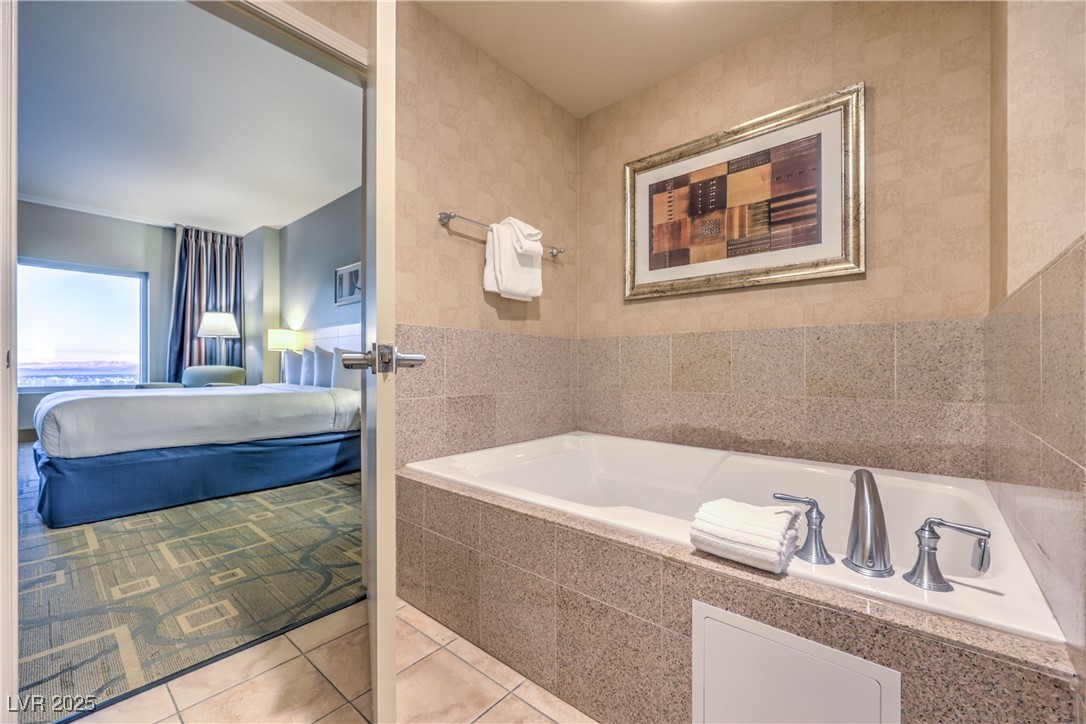 211 East Flamingo Road, Unit 1508 Las Vegas, NV 89169 - Photo 24 of 40 Ensuite bathroom with a bath and light tile patterned floors