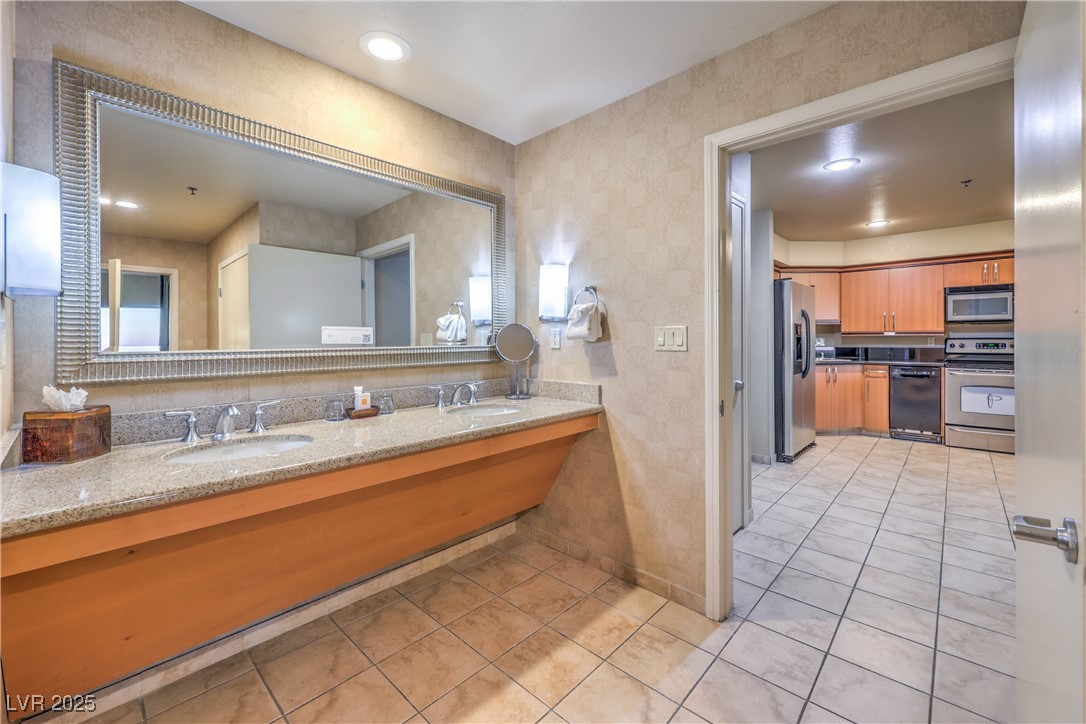 211 East Flamingo Road, Unit 1508 Las Vegas, NV 89169 - Photo 25 of 40 Bathroom with double vanity and light tile patterned floors