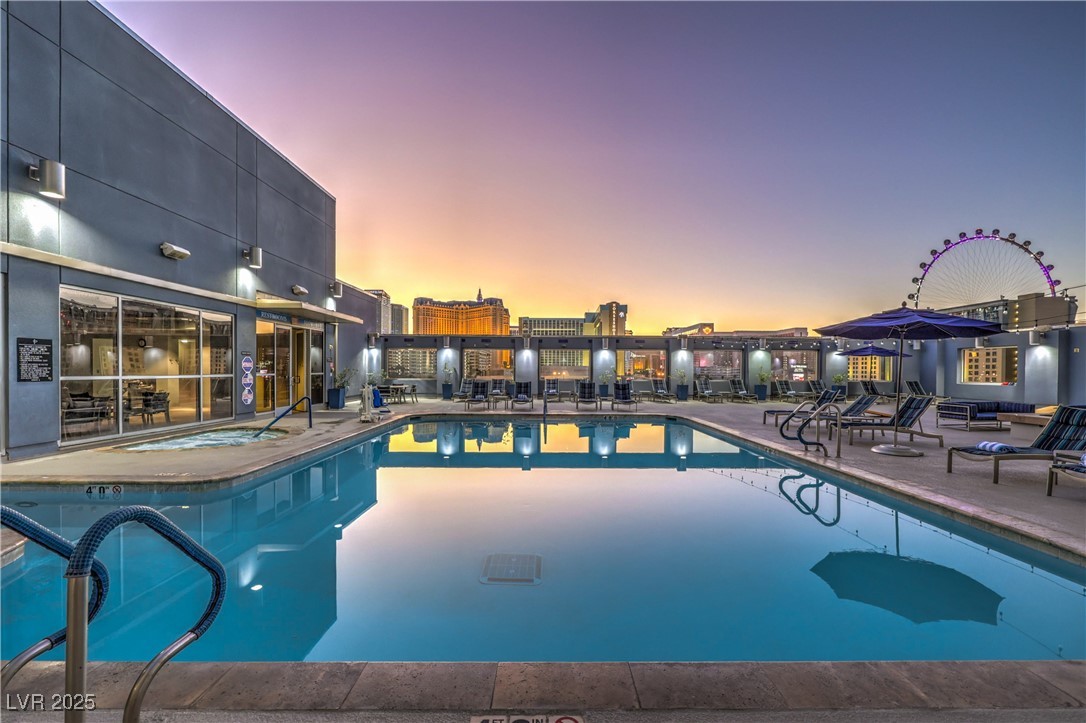 211 East Flamingo Road, Unit 1508 Las Vegas, NV 89169 - Photo 36 of 40 Pool at dusk with a community pool and a patio area