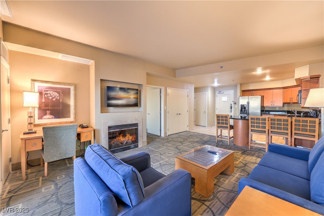 211 East Flamingo Road, Unit 1508 Las Vegas, NV 89169 - Photo 8 of 40 Living room featuring a tiled fireplace