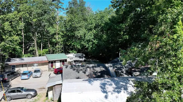 a view of a house with a yard and a car park