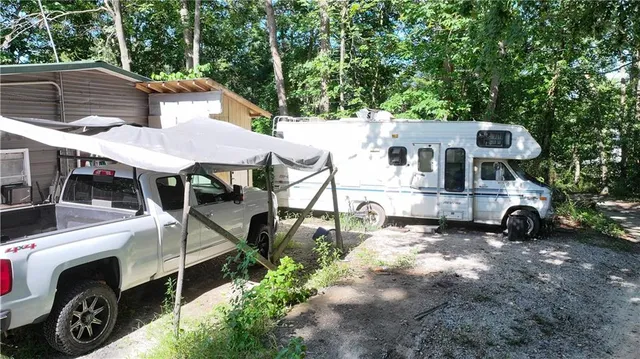 a view of a two chairs in the backyard