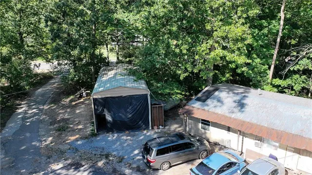 a view of a chairs and table in backyard