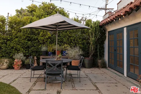 a view of a patio with furniture and barbeque grill