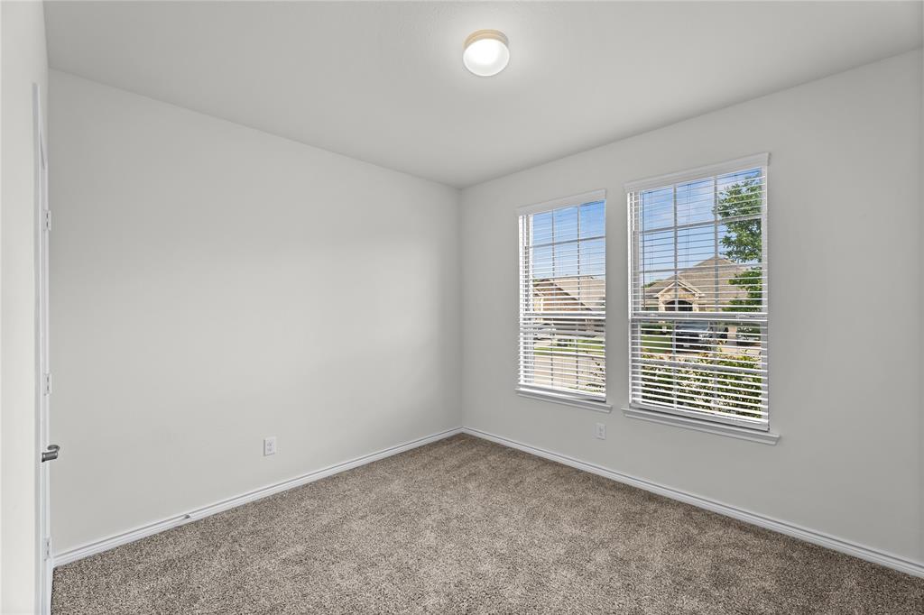 2908 Frio Road Little Elm, TX 75068 - Photo 17 of 26 Neutral wall paint, plush carpeting, and two windows with blinds