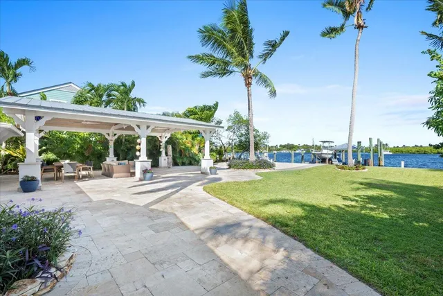 a view of a house with a yard patio and a swimming pool