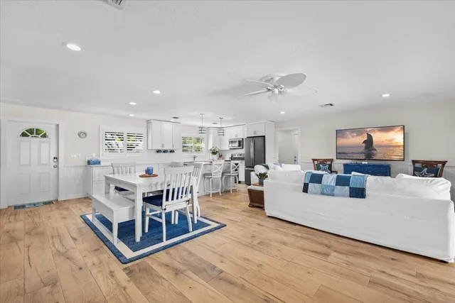 a view of a dining room with furniture and wooden floor