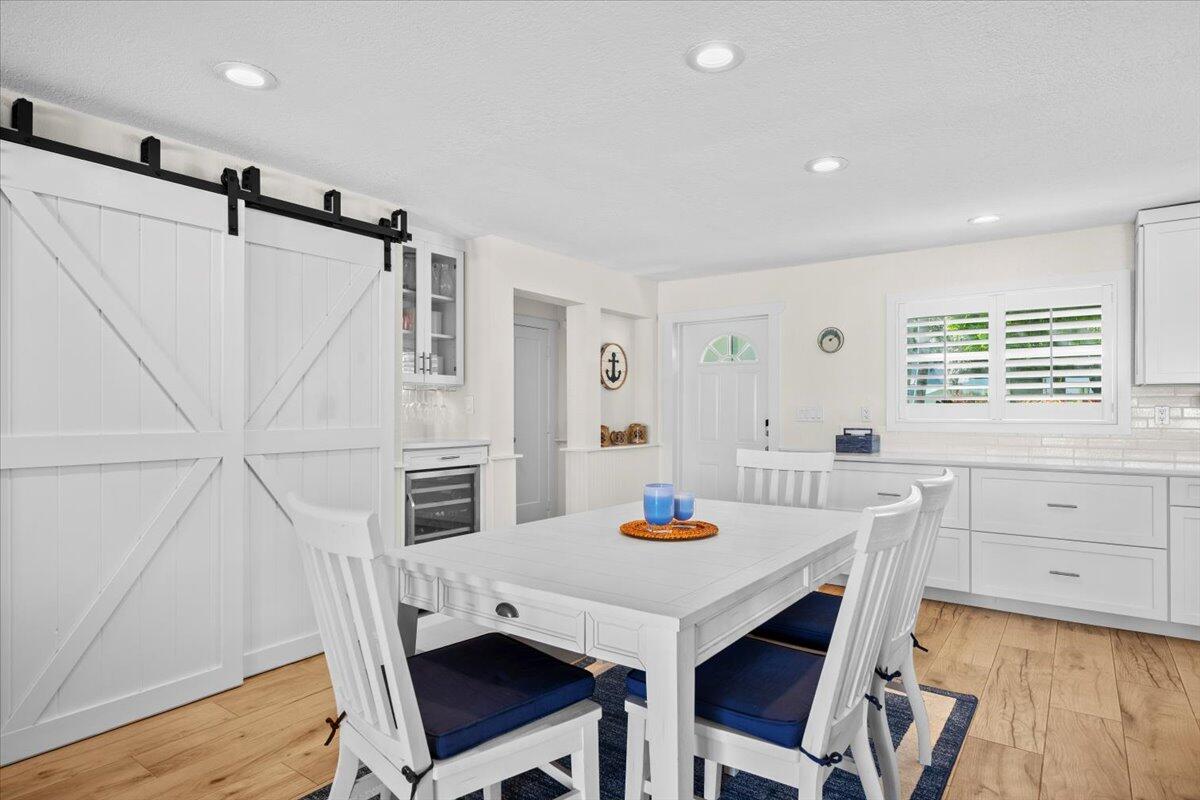 119 Elsa Road Jupiter, FL 33477 - Photo 22 of 38 a view of a dining room with furniture and wooden floor